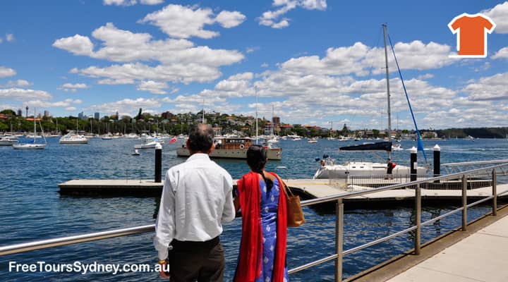 An elderly couple on a sightseeing bus tour enjoy the stunning views of Rose Bay, one of the most beautiful bays of Sydney Harbour. Rose Bay is known for its luxury homes, picturesque waterfront, and sheltered coves.