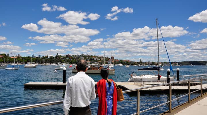 An elderly couple on a sightseeing bus tour enjoy the stunning views of Rose Bay, one of the most beautiful bays of Sydney Harbour. Rose Bay is known for its luxury homes, picturesque waterfront, and sheltered coves.