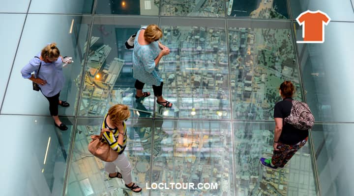 Tourists marvel at a detailed miniature model of the Sydney CBD reproduced beneath a glass floor, a popular attraction showcasing the city in miniature.