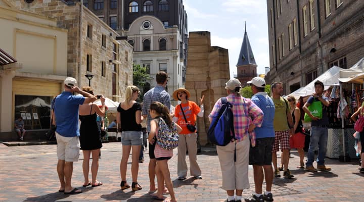 A group of tourists listening stories of early colony